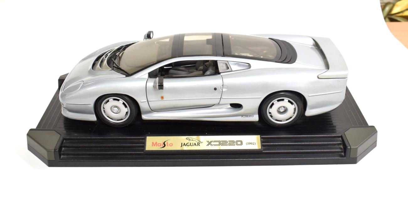 Lot 3142 - Maisto: A Metal Scale Model of a Jaguar XJ220, 1992, mounted on a plastic display board, 47cm...