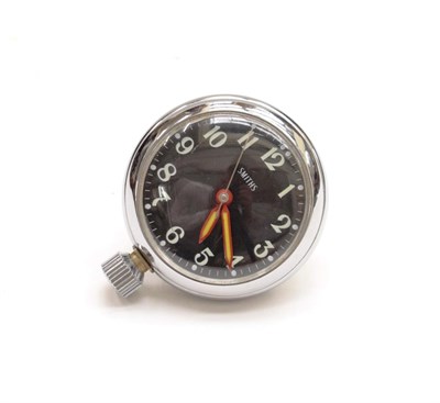 Lot 3165 - A Smiths Chrome Plated Dashboard Clock, with black dial, white numerals and a winding baton to...