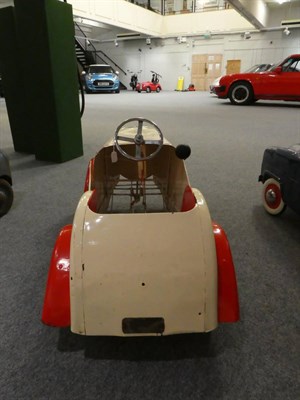 Lot 3221 - A 1930's Child's Pedal Car, repainted cream and red, with chromed three-spoke steering wheel,...