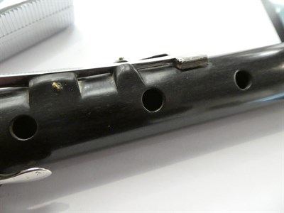 Lot 23 - Flute made from black wood with ivory joint rings and crown, three joints and the head stamped...