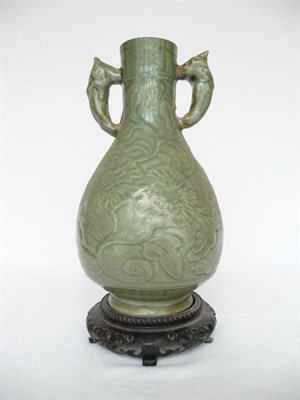 Lot 130 - A Longquan Celadon Bottle Vase, Ming Dynasty (1368-1644), with mask handles carved with...