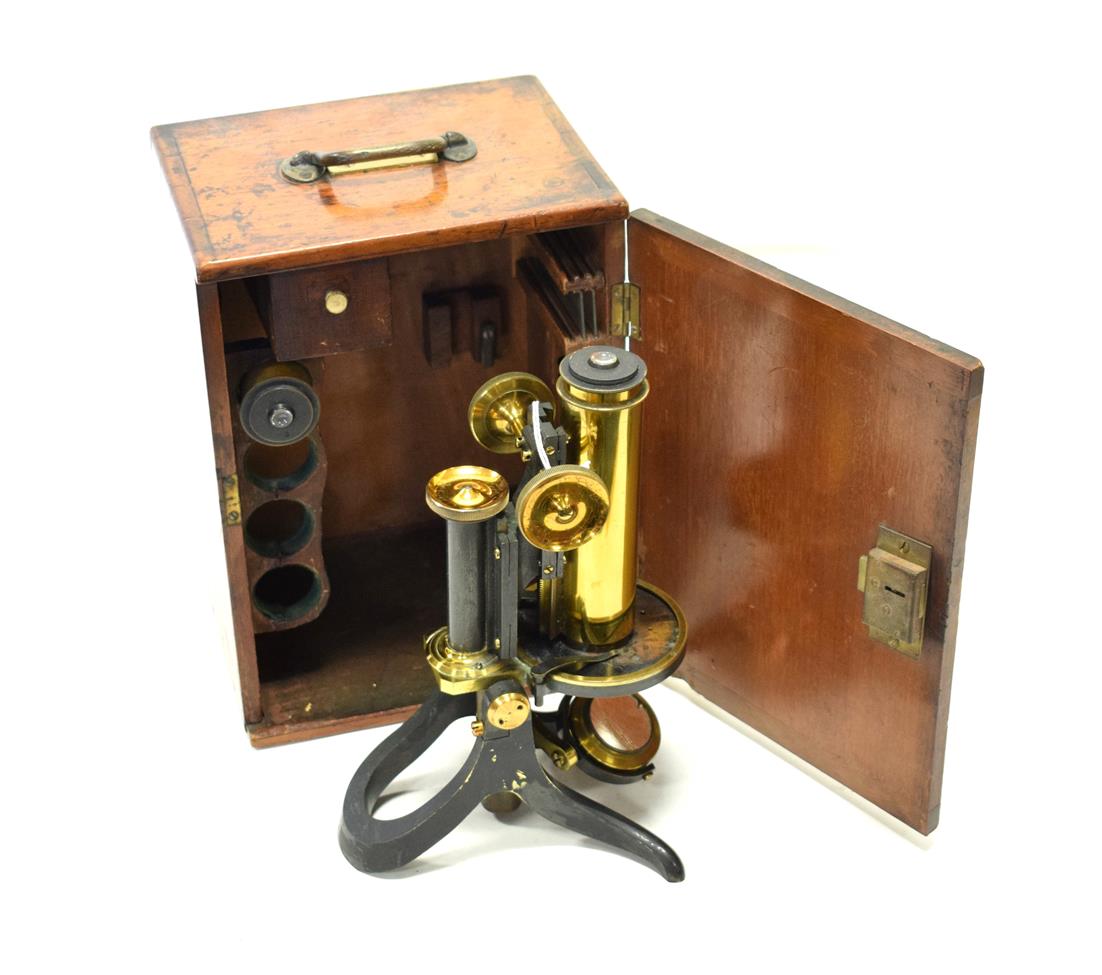 Lot 93 - Swift & Son Brass Microscope with circular stage, plano-concave mirror, black lacquered tilting...