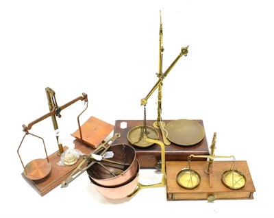 Lot 106 - Beam Balances three examples on wooden bases and a further example with copper bowl pans (4)