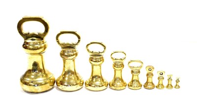 Lot 108 - Set Of Brass Bell Weights 14lb, 7lb, 4lb, 2lb, 1lb, 8oz, 4oz, 2oz and 1oz with indistinct stampings