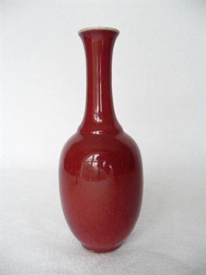 Lot 145 - A Chinese Sang de Boeuf Glazed Bottle Vase, 18th/19th century, with slender slightly conical...
