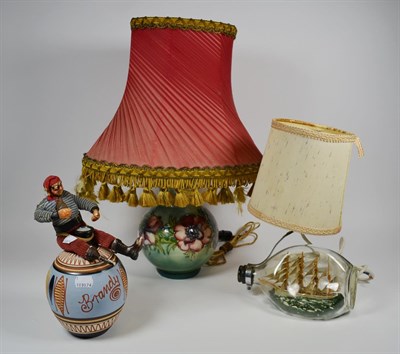 Lot 11 - Moorcroft pottery Anemone pattern table lamp, another ship in bottle table lamp, pottery brandy...