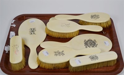 Lot 18 - A late Victorian four-piece, ivory mounted dressing table set, and another similar, differently...