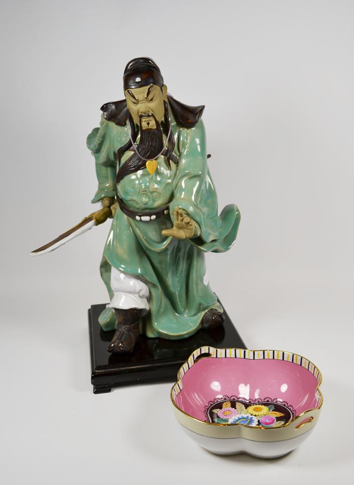Lot 43 - A large Chinese celadon glazed figure of a warrior, 20th century on plinth base; with a...
