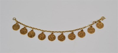 Lot 63 - A bracelet hung with ten tokens, length 17cm