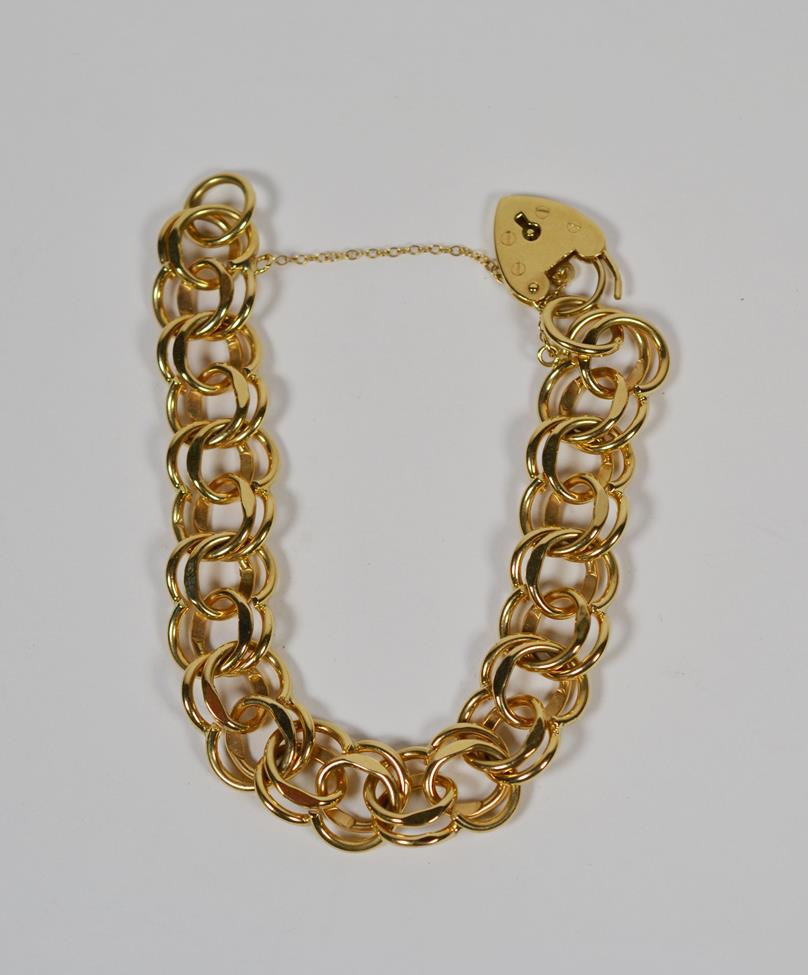 Lot 73 - A 9 carat gold double link bracelet with padlock clasp, length 19cm