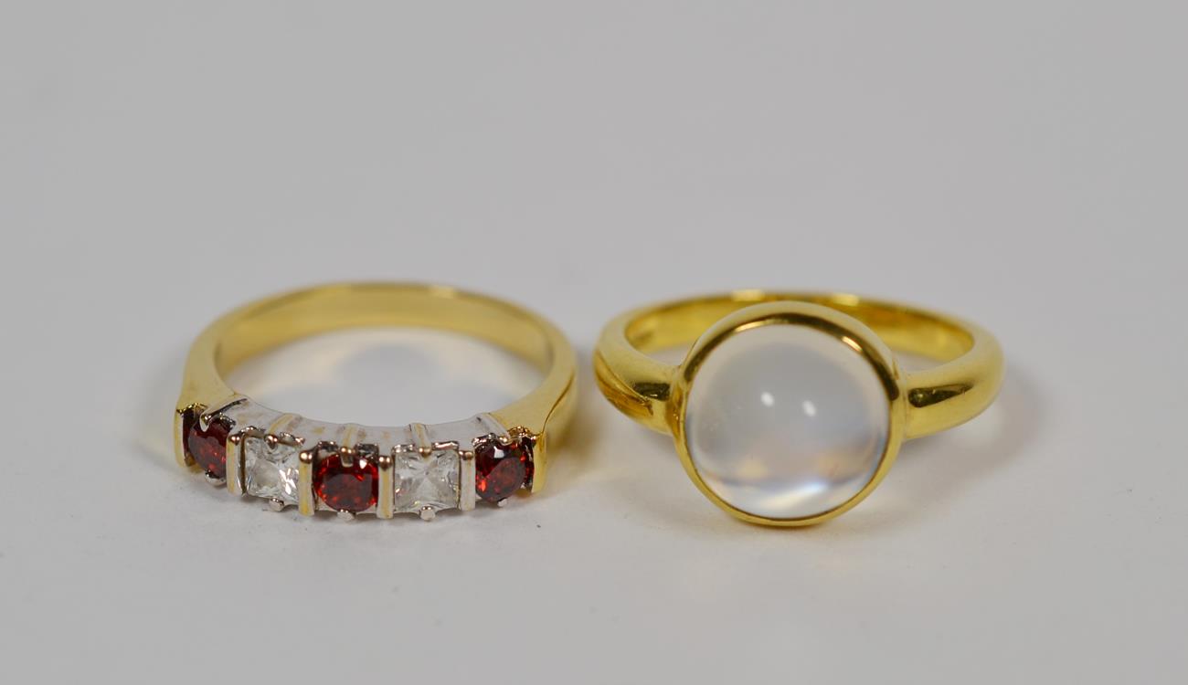 Lot 95 - An 18 carat gold moonstone ring, finger size L1/2; and a red and white five stone ring, finger size