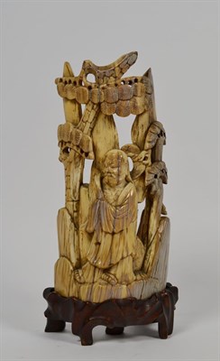 Lot 121 - A Chinese Ming ivory scholar figure on stand