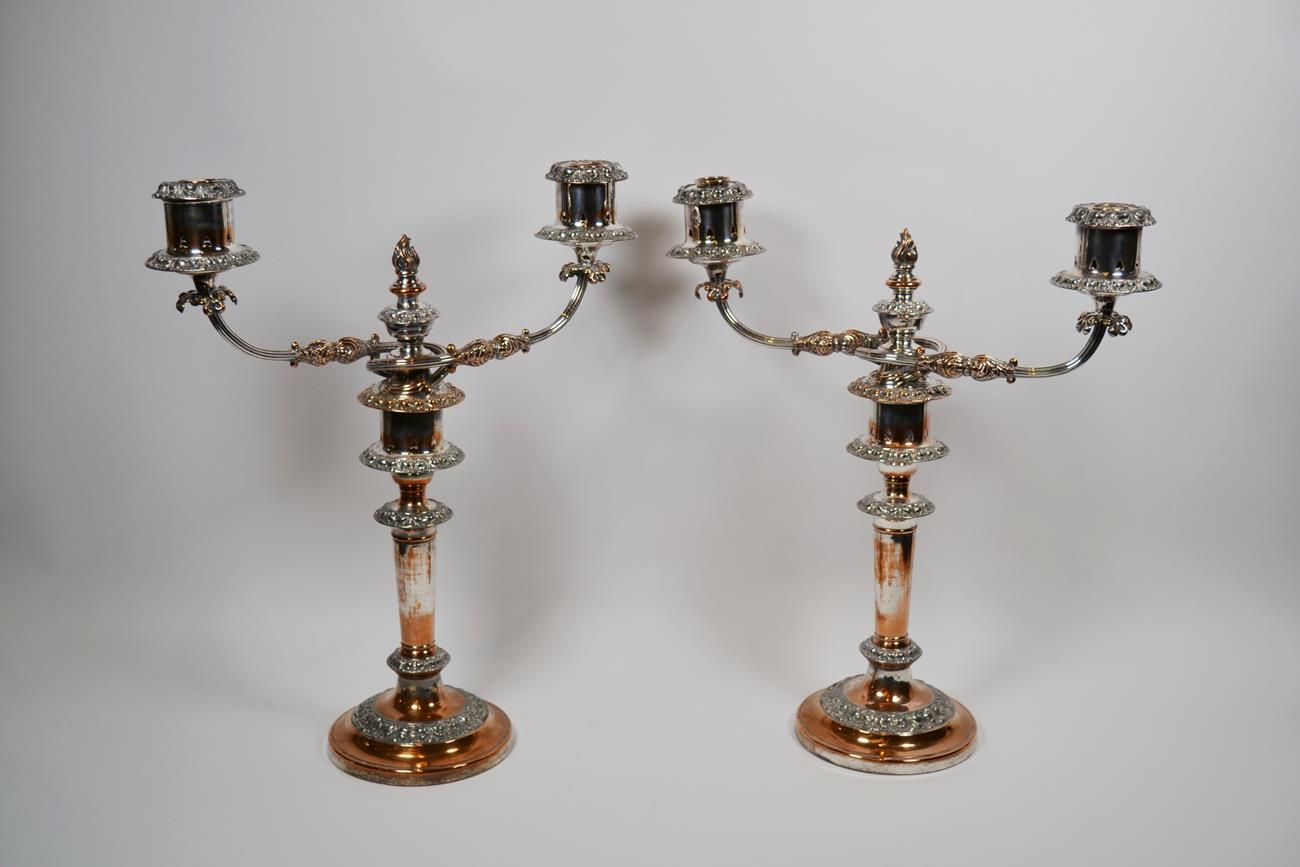 Lot 129 - A pair of silver-plated two-light candelabra, 19th century, each on circular base with foliage...