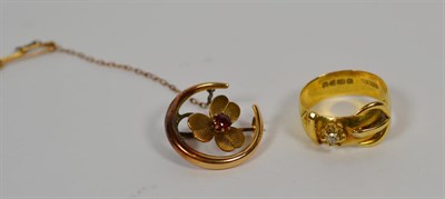 Lot 161 - An 18 carat gold diamond set buckle ring, finger size U; and an Edwardian ruby set yellow metal...