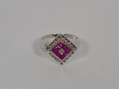 Lot 163 - A ruby and diamond cluster ring, stamped 'K18', finger size N