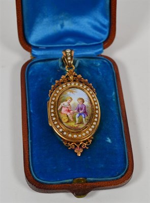 Lot 171 - A French locket with a porcelain panel and a seed pearl border, length 6cm