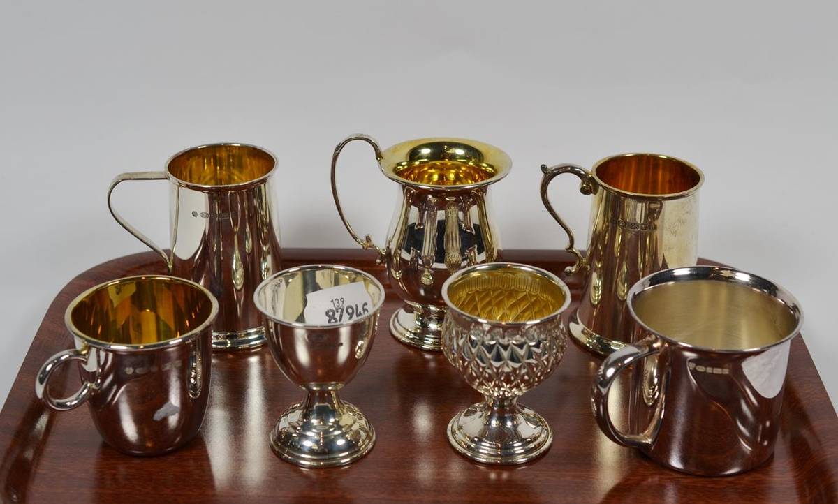 Lot 189 - Five Elizabeth II silver mugs, two by Carrs, Sheffield, 2004 and 2010; one by Broadway and Co.,...