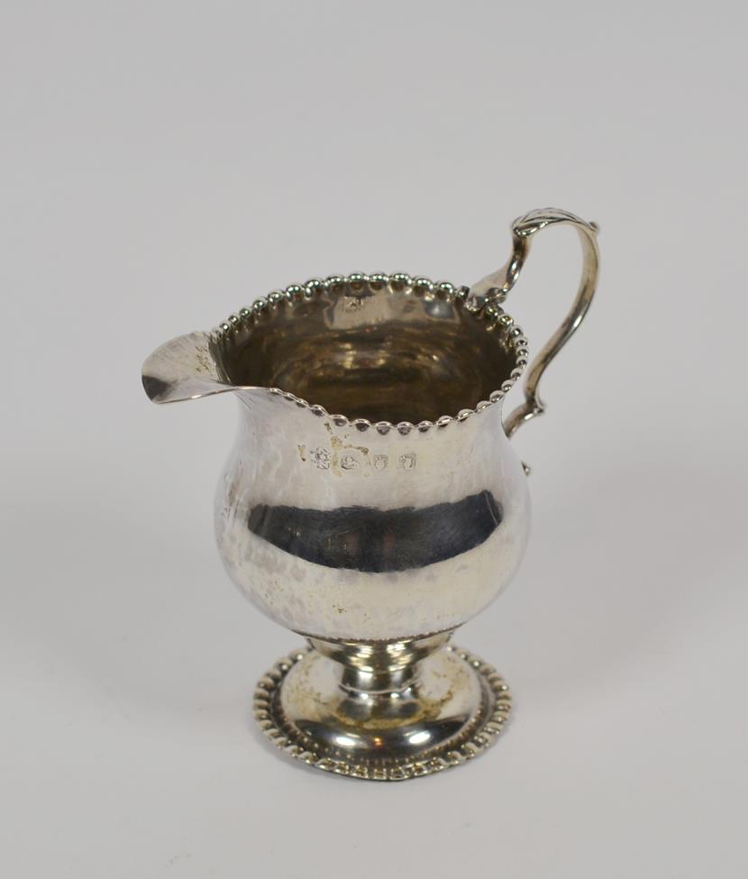 Lot 200 - A George III silver cream-jug, maker's mark NS and AN, London, 1766, baluster and with beaded...