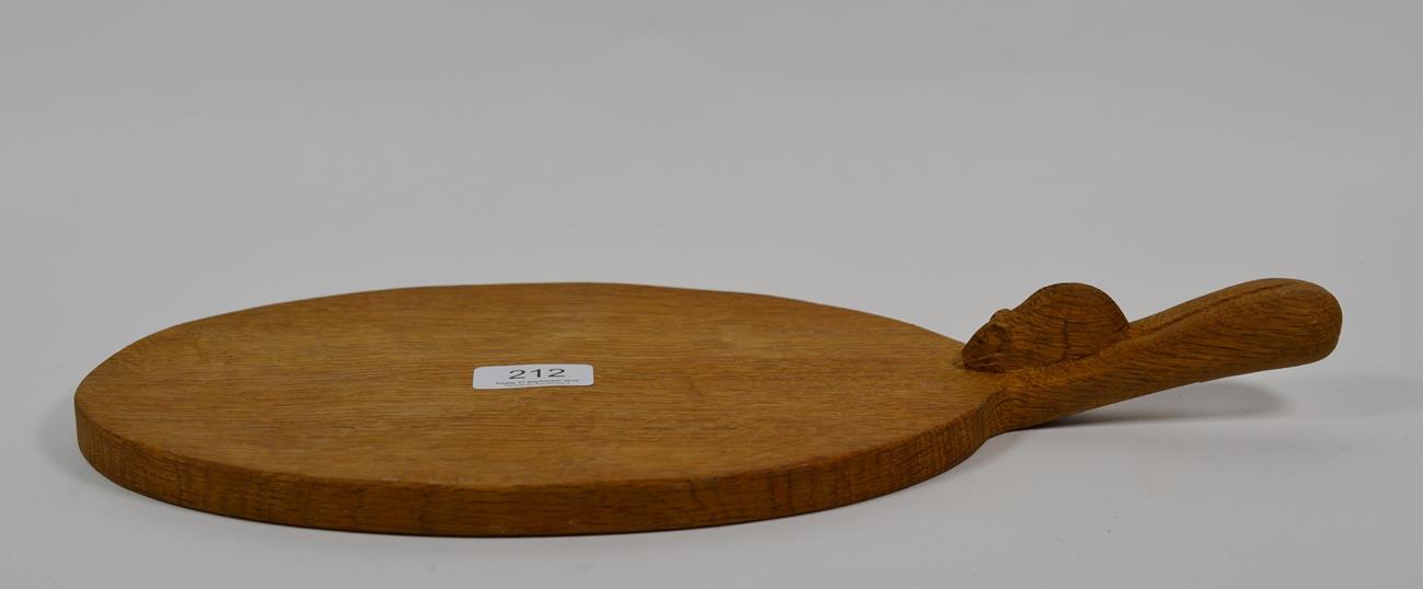 Lot 212 - Mouseman: A Robert Thompson English oak cheeseboard, carved mouse signature, 39cm length