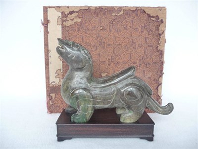 Lot 167 - A Chinese Jade Figure of a Qilin, circa 1930, modelled on one of the stone guardians of the Nanjing