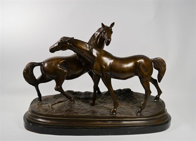 Lot 275 - A bronzed spelter model of two horses on an oval marble base