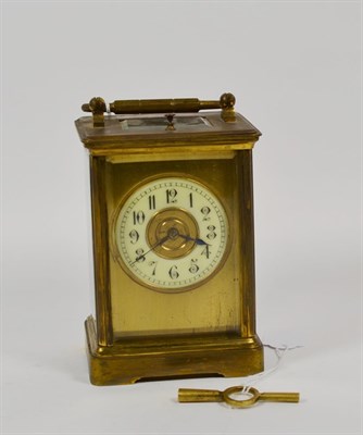 Lot 317 - An early 20th century brass repeater carriage clock, white enamel Arabic chapter ring within...