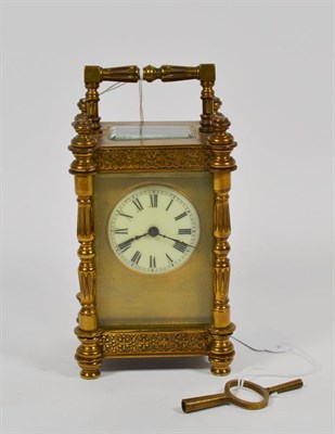 Lot 322 - A late 19th/early 20th century brass carriage clock, white enamel Roman dial within gilt face,...