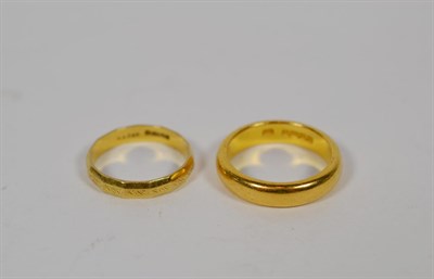 Lot 348 - An 18 carat gold textured band ring, finger size P; and a 22 carat gold band ring, finger size R1/2