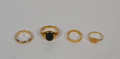 Lot 364 - A 9 carat gold bloodstone signet ring, finger size V; a 9 carat three colour gold band ring, finger