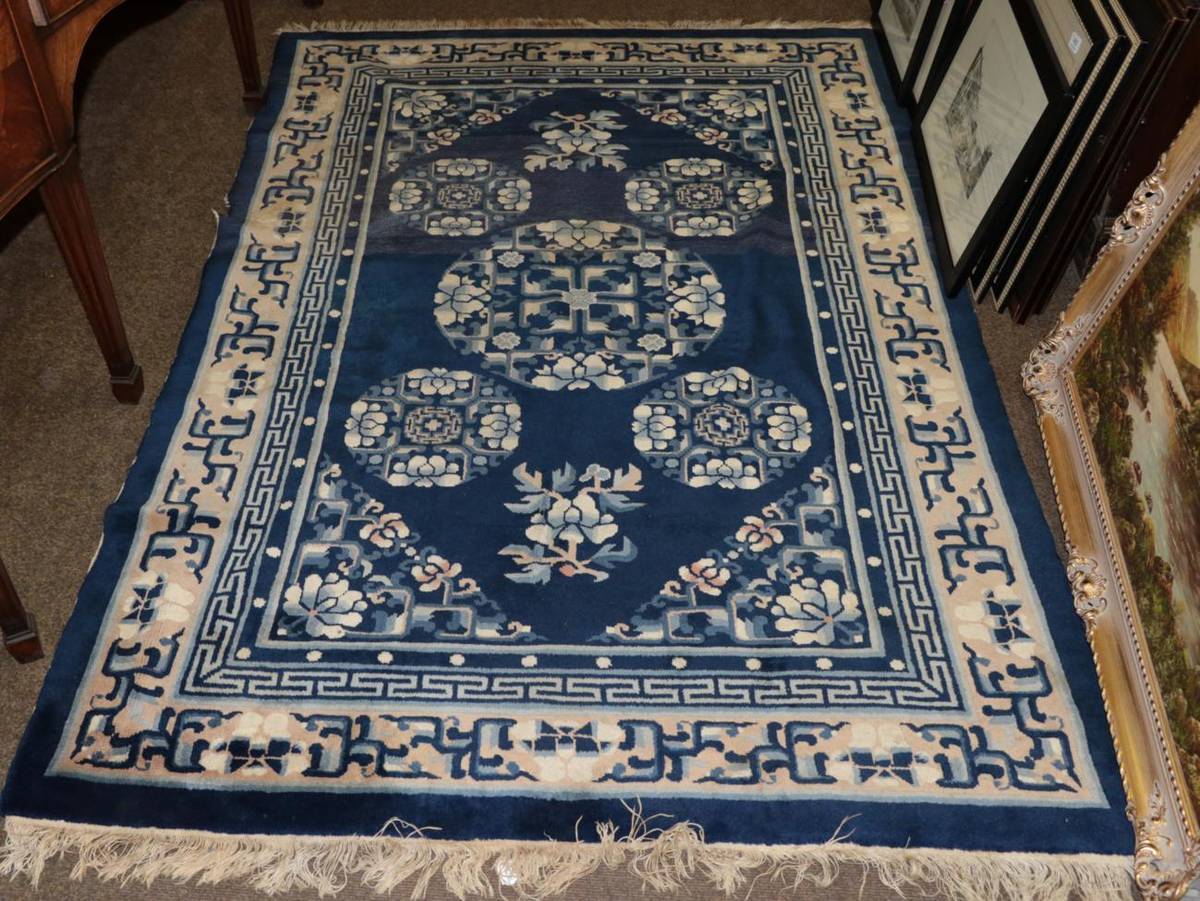 Lot 481 - Chinese Rug, the indigo field with five roundels enclosed by stylised vine borders, 199 by 131cm