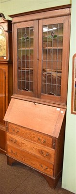 Lot 482 - An oak bureau bookcase with leaded glass doors, circa 1900