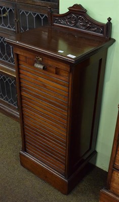 Lot 486 - A late Victorian mahogany tambour front office cabinet, late 19th century, the carved...