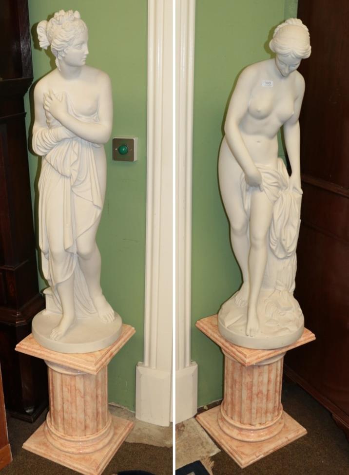 Lot 503 - Two large bisque style figures of maidens on faux pink marble bases