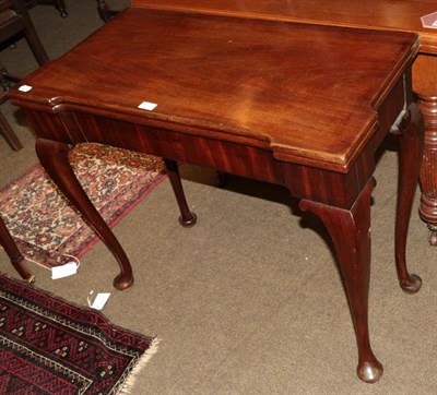 Lot 513 - A George III scissor action mahogany fold over tea table