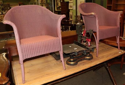 Lot 517 - Two sets of weighing scales and a pair of pink Lloyd Loom chairs (4)