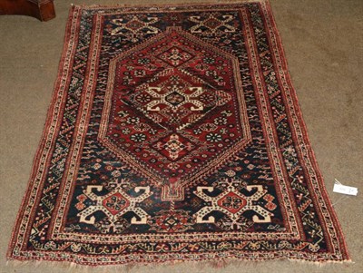 Lot 523 - Kashgai rug, the madder lozenge field framed by spandrels and indigo borders, 155 by 105cm