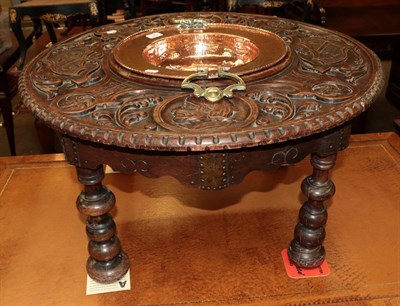 Lot 525 - A 19th century Continental circular occasional table with carved top, inset with a copper bowl with