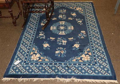 Lot 534 - Chinese rug, the indigo field with roundel medallion framed by spandrels and diamond lattice...