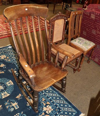 Lot 546 - A country rocking chair, a carved oak hall chair and one other (3)