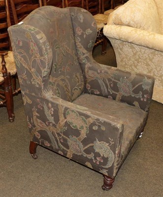 Lot 549 - A 19th century mahogany wing arm chair upholstered in a fabric woven with squirrels and exotic...