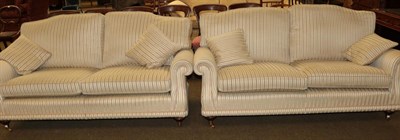 Lot 552 - A pair of good quality modern three seater settees upholstered in cream stripes