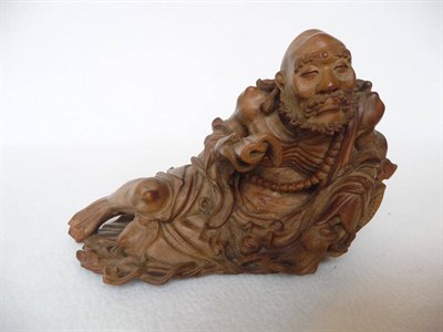 Lot 198 - A Chinese Carved Hardwood Figure of an Immortal, 18th/19th century, the emaciated sage half...