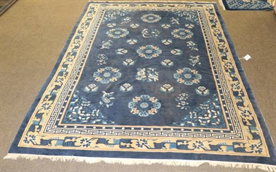 Lot 560 - Chinese rug, the indigo field with seven roundels enclosed by pale lemon borders, 244 by 170cm