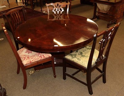 Lot 562 - A reproduction mahogany circular dining table, in Regency style, with plain frieze on a...