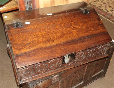 Lot 566 - An 18th century oak bible box with carved frieze