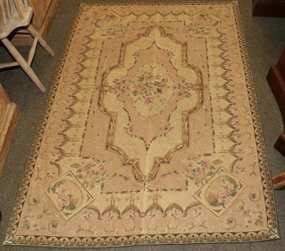 Lot 574 - Chinese needlepoint rug of Aubusson design, the field with naturalistic flowers enclosed by...