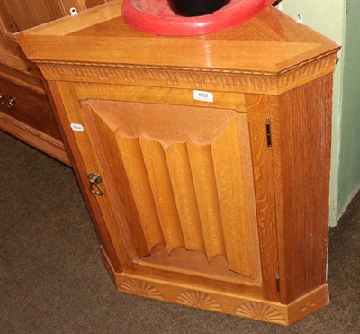 Lot 582 - Light oak hanging corner wall cabinet