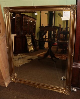 Lot 585 - Reproduction gilt bevel glass mirror with moulded frame, 132cm by 106cm