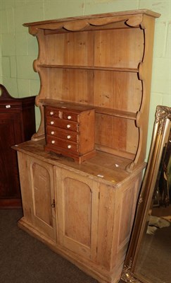 Lot 586 - A Victorian pine kitchen dresser, the rack with two shelves, the base of two moulded cupboard doors