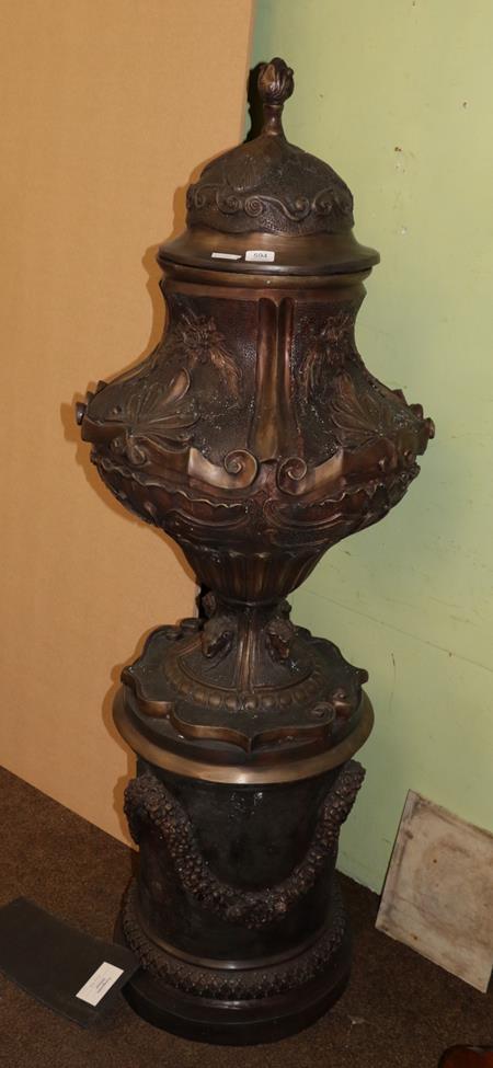 Lot 594 - A large reproduction metal pedestal urn on stand